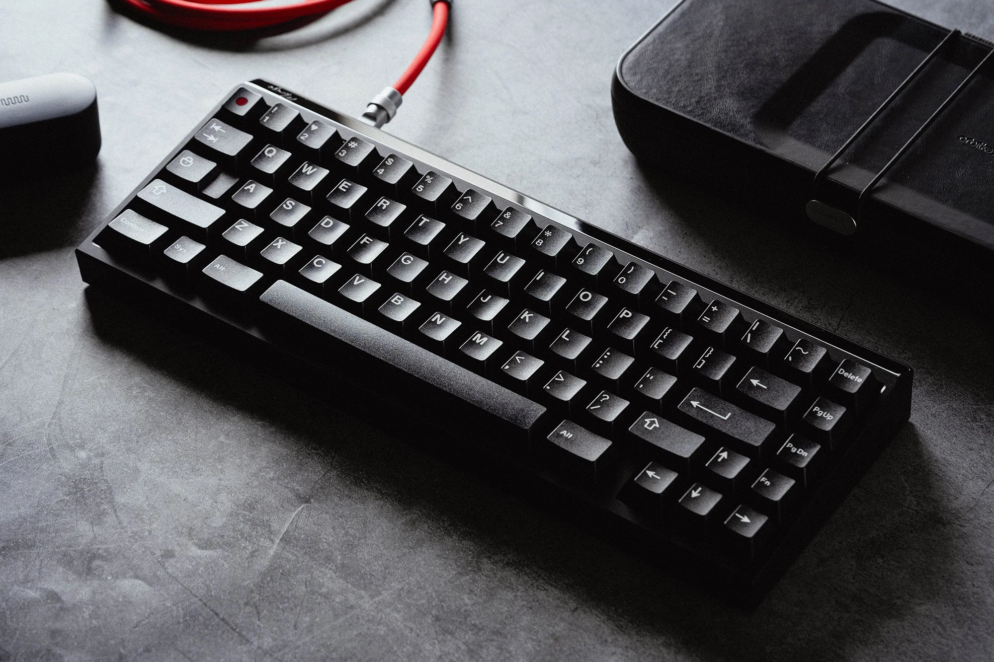Black mechanical keyboard and wrist rest on a desk