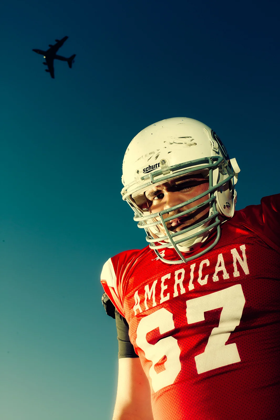 Football player in a red jersey beneath a blue sky