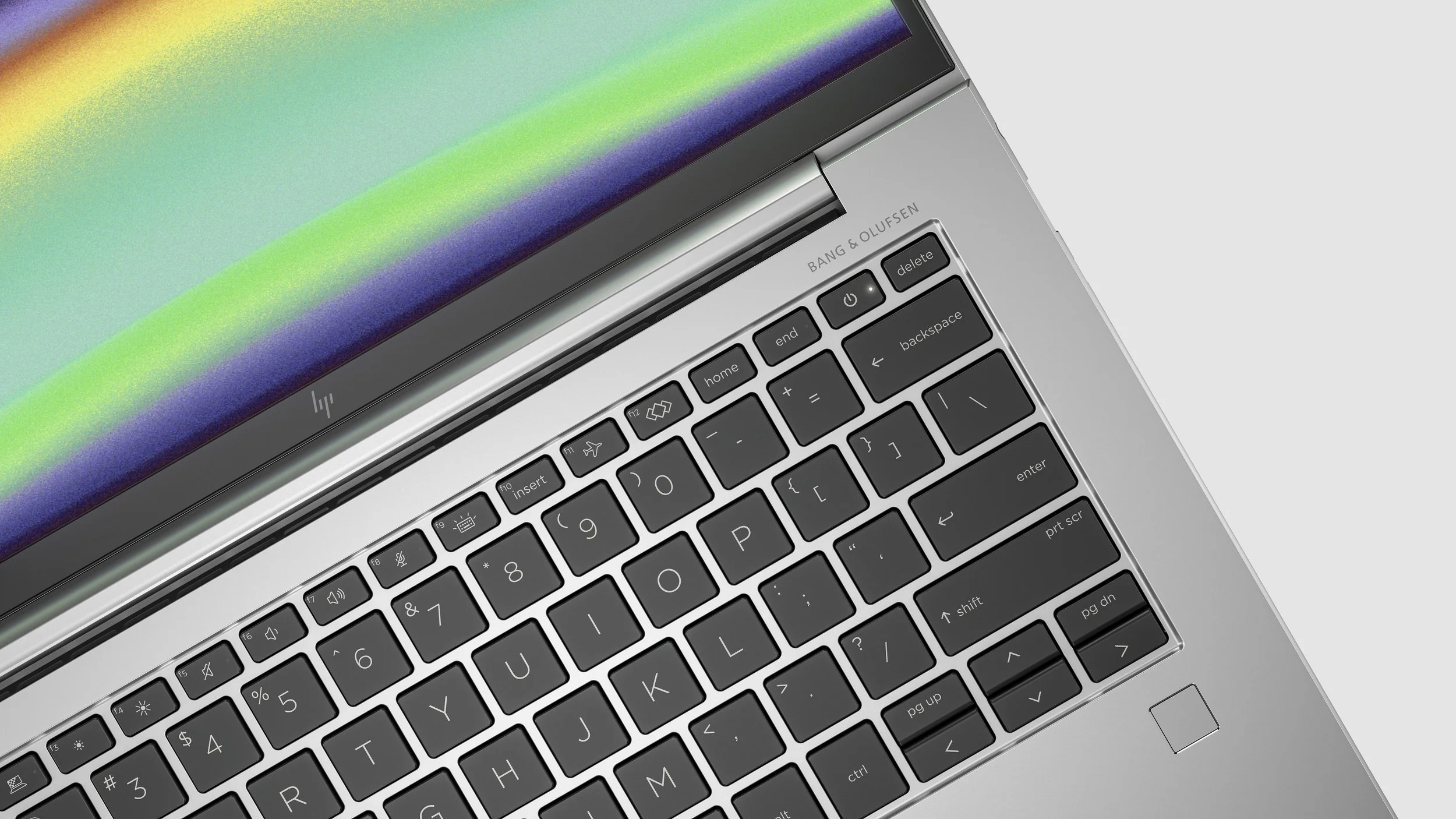 Top-down close-up of an open silver laptop keyboard